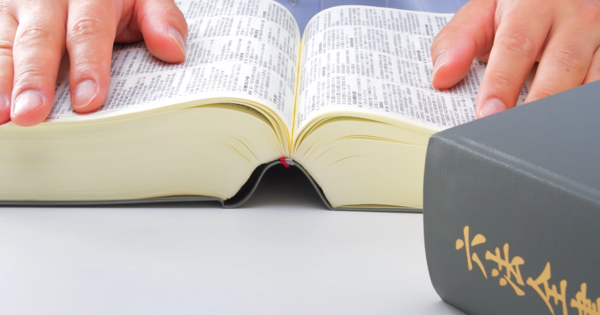 退去費用の法的根拠を調べるために六法全書を開いている様子