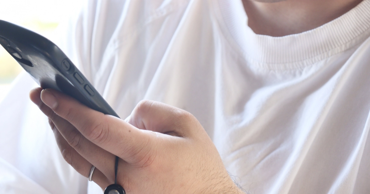 退去費用について片手でスマートフォンを操作して調べている様子